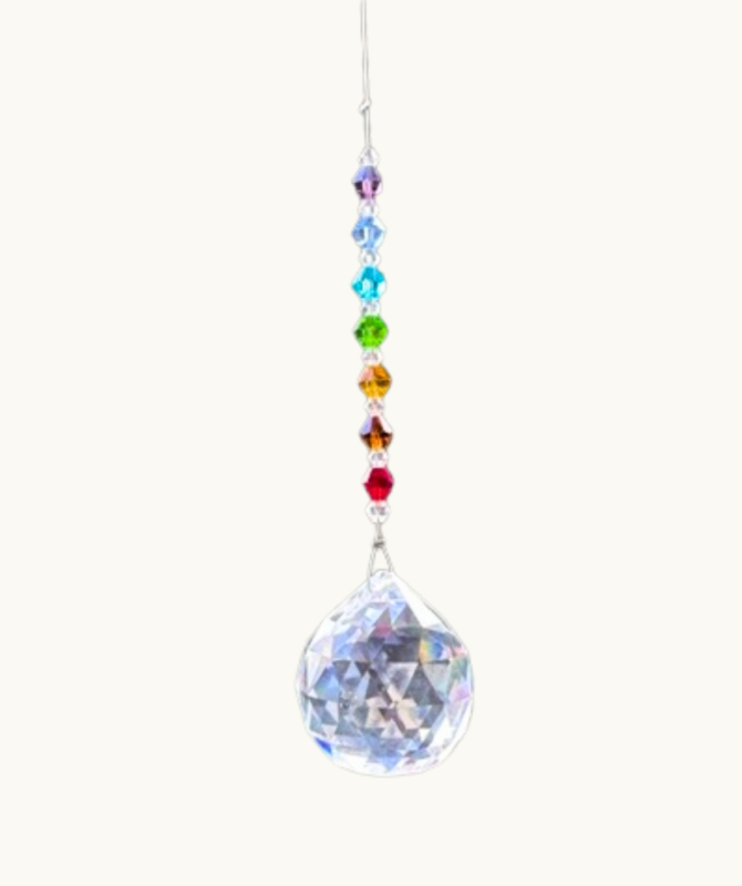 This image shows a mini Crystal Chakra Sun Catcher - hanging with coloured crystal beads and a larger crystal below