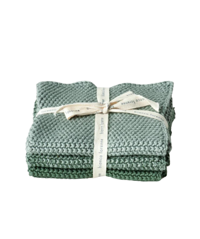 Bianca Lorenne sage wash cloth. Bundle of three, from dark sage at the bottom of the pile, to mid and light at the top. Folded in a bundle with a ribbon around them.